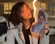 Iranian Women Defy Regime, Light Cigarettes with Burning Photo of Supreme Leader
